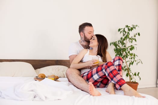 Breakfast in bed a married couple in the morning in the bedroom 1