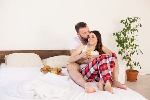 Breakfast in bed a married couple in the morning in the bedroom 1