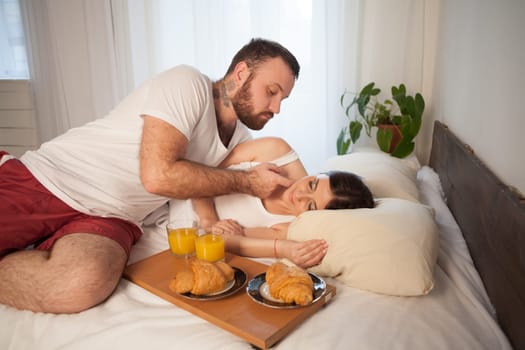 Breakfast in bed a married couple in the morning in the bedroom 1