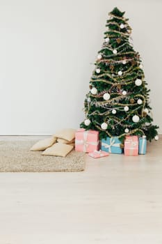 Christmas tree with gifts for the new year in the interior of the room