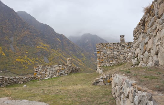 Cloudy foggy sky, mountain peaks covered with fog in the morning. Caucasus Mountains, Upper Balkaria, Russia