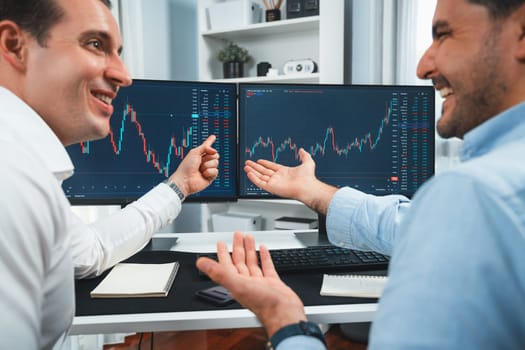 Successful stock exchange traders focusing on high profit chart investment on dynamic database, analyzing on monitor. Concept of discussing financial technology growth at workplace. Sellable.