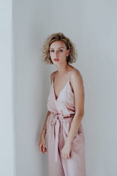 beautiful fashionable woman in a pink jumpsuit