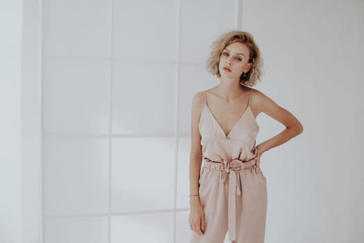 Portrait of a beautiful woman in a pink jumpsuit