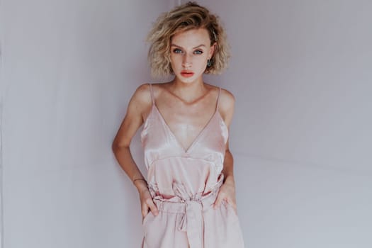 Portrait of a beautiful woman in a pink jumpsuit