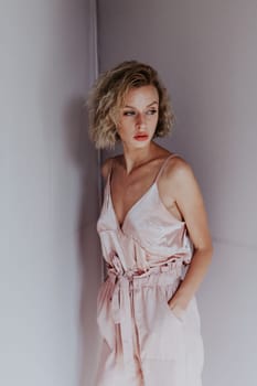 Portrait of a beautiful woman in a pink jumpsuit