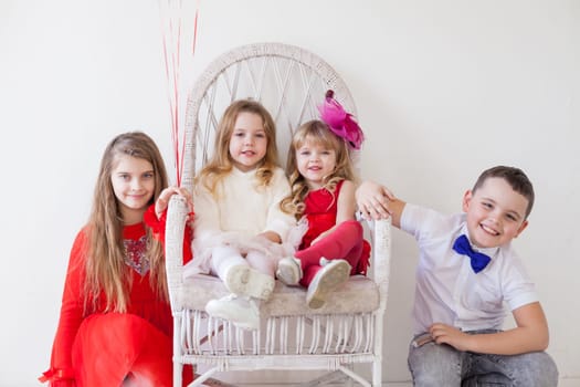 beautiful girls and boy in red and white clothes on birthday party