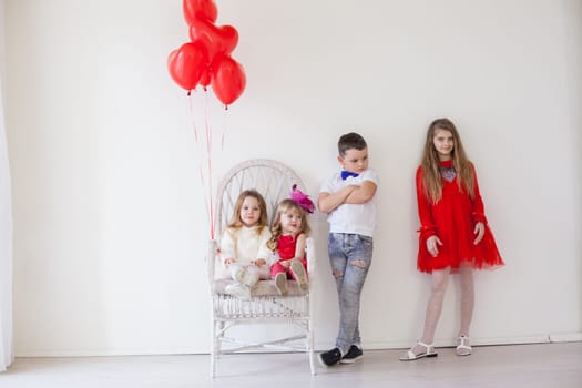 beautiful girls and boy in red and white clothes on birthday party