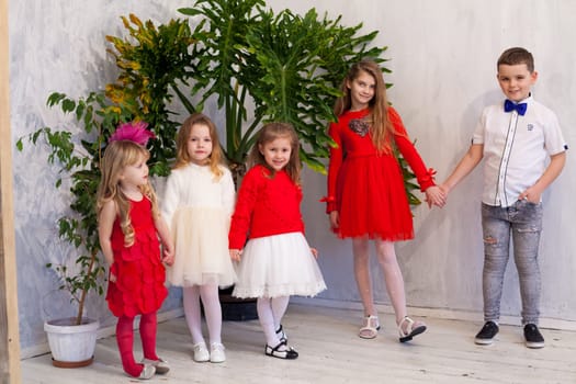 beautiful girls and boy in red and white clothes on birthday party