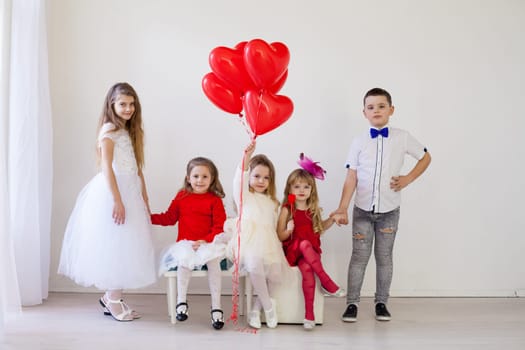 Girls and boy on holiday with balloons