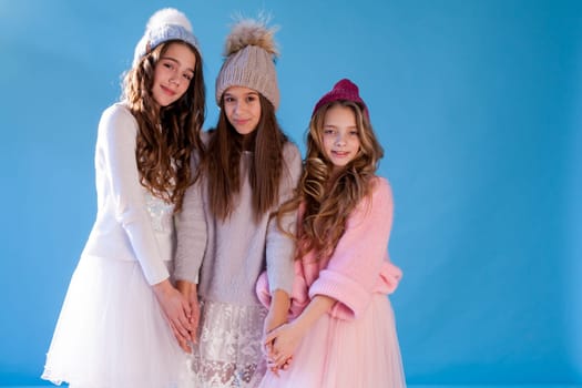 Three beautiful fashionable girls in winter cap