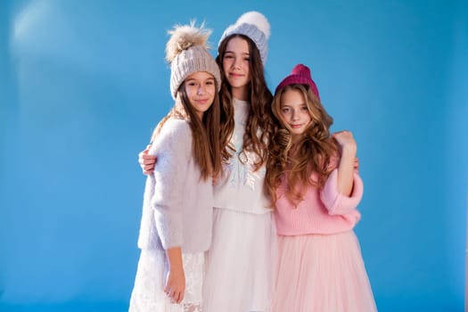 Three beautiful fashionable girls in winter cap