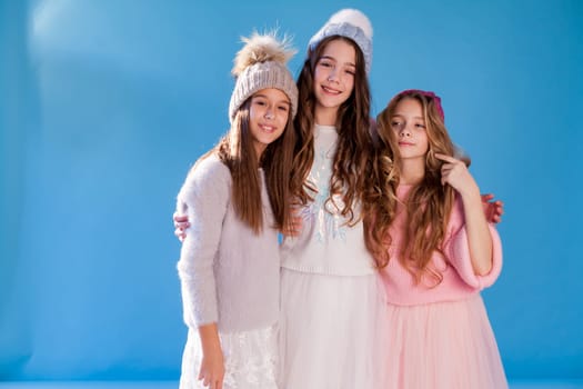 Three beautiful fashionable girls in winter cap