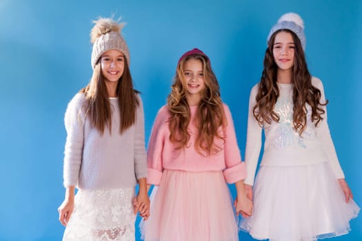 Three beautiful fashionable girls in winter cap