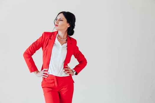 Portrait of a beautiful woman in a red business suit in the office