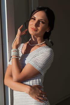 Portrait of a beautiful woman in a grey striped dress