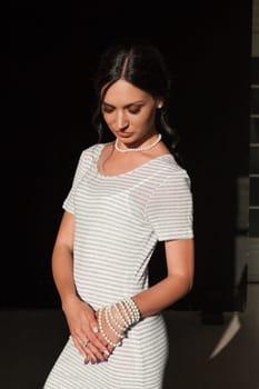 Portrait of a beautiful woman in a grey striped dress