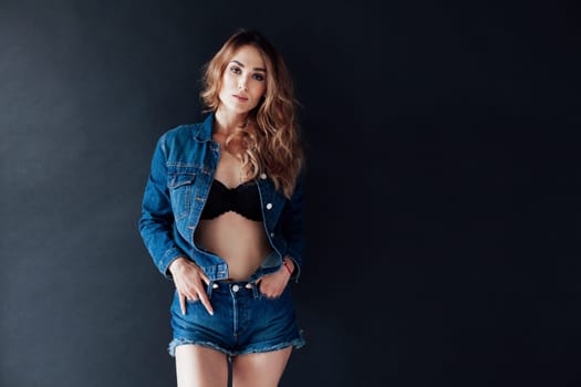 Portrait of a fashionable woman in denim shorts jacket and lingerie