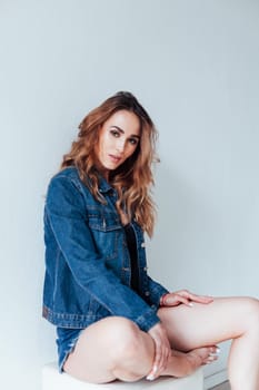 Portrait of a fashionable woman in denim shorts and lingerie
