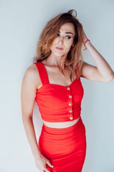 Portrait of a beautiful woman in a red business suit in the office