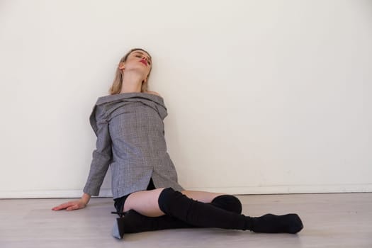 Portrait of a beautiful blonde woman in lingerie and boots