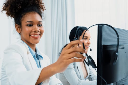 African American young businesswoman wearing headset working in office to support remote crucial customer or colleague. Call center, telemarketing, customer support agent provide service on video call