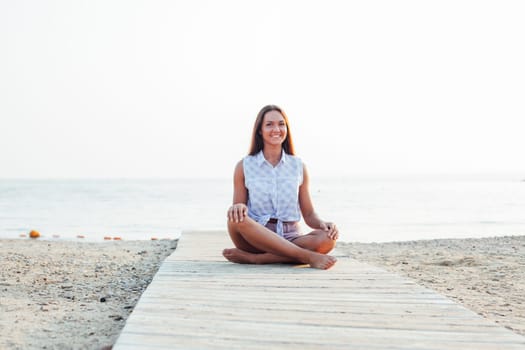 portrait of a woman with long hair on the beach by the sea