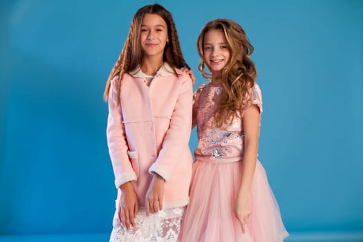 Two beautiful girl girlfriends in pink and white dresses