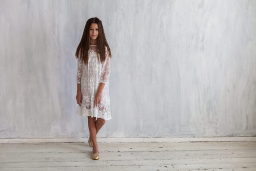 Portrait of a beautiful girl in a white dress