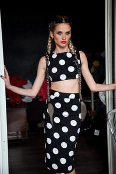 Beautiful woman with braids in a polka dot dress