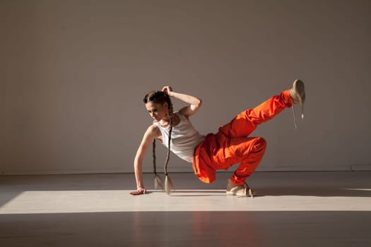 Beautiful woman with braids dances to music