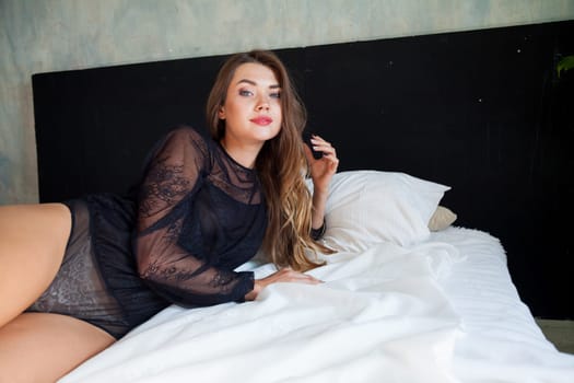 portrait of a beautiful woman in lingerie in the bedroom on the bed