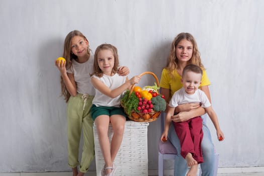 beautiful kids friends family with a basket of ripe vegetables and fruits