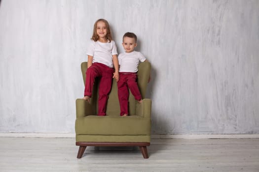 boy with girl brother and sister sitting next to each other in the room