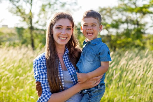 Portrait of a woman with her son on a walk in nature