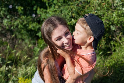 woman plays with beloved son on a walk