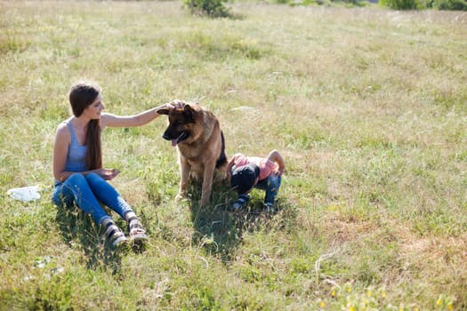 woman plays with german Shepherd dog on walk