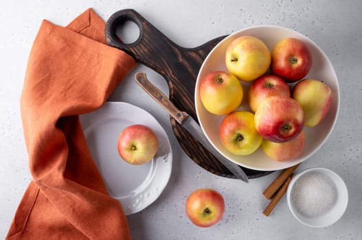 Top view of beautiful ripe apples on a plate with a knife and napkin. Selective focus.