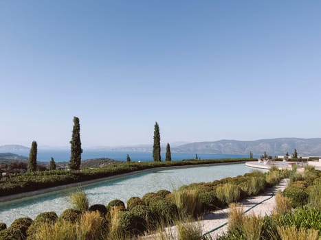 Long pool over the sea against the backdrop of mountains. Hotel Amanzoe, Greece. High quality photo