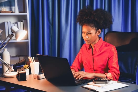 African woman businesswoman or blogger wearing pink shirt with serious face, looking and focusing on screen laptop with struggle project. Concept of stressful expression at work from home. Tastemaker.