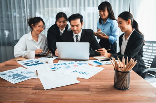 Focus financial data dashboard paper by business intelligence display graph, chart and statistic report on office table with blurred business people working in background. Habiliment