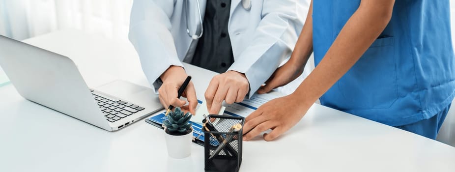 Professional various team of medical working and planning medical treatment at hospital table together. Teamwork lead to successful illness and sickness treatment. Panorama Rigid