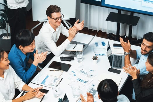 Analyst team leader celebrate with his colleague after successful data analysis meeting using FIntech software power with business intelligence or BI dashboard. Prudent