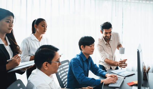 Group of diverse office worker employee working together on strategic business marketing planning in corporate office room. Positive teamwork in business workplace concept. Prudent