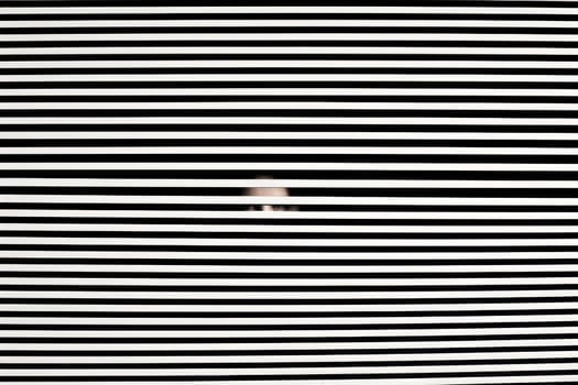 Scary eye peek out of strip lines abstract concept of unhappy vision minimal comeliness