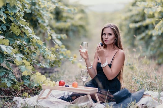 Picnic and wine tasting at sunset in the hills of Italy, Tuscany. Vineyards and open nature in the summer. Romantic dinner, fruit and wine.