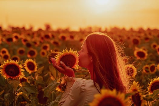 Woman in the sunflowers field. Summer time. Young beautiful woman standing in sunflower field.