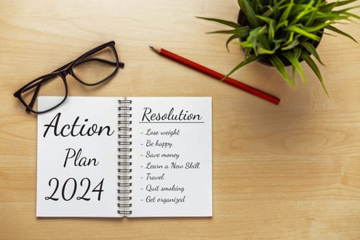 2024 Happy New Year Resolution Goal List and Plans Setting - Business office desk with notebook written about plan listing of new year goals and resolutions setting. Change and bliss concept.