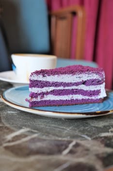 cutting A piece of purple velvet cake with cream .