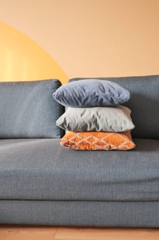 modern sofa with pillows in living room at home.